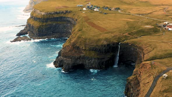 Flying Above Gasadalur Village and Mulafossur Waterfall in the Faroe Islands