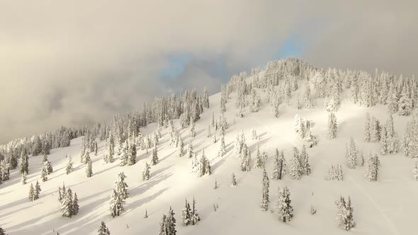 Aerial View of Canadian Nature Landscape on Top of Snow Covered Mountain