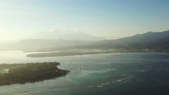 Luxury fly over travel shot of a white sand paradise beach and turquoise sea background in colourful