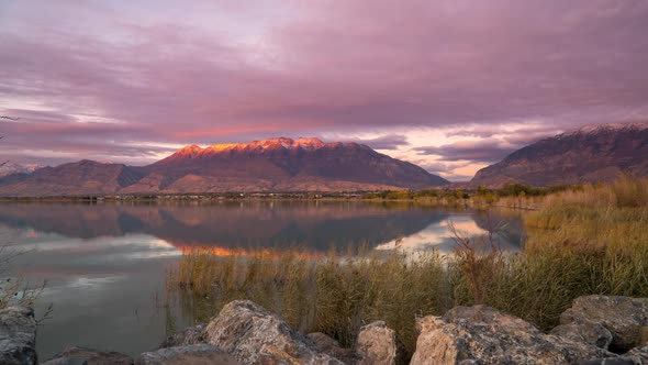 Time lapse of mountain refection during colorful sunset