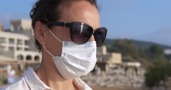 Woman in Mask on Beach