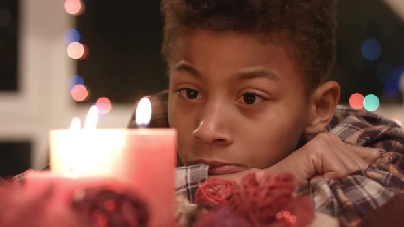 Sad Boy Looking at Candle