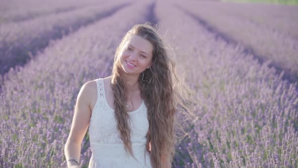 Beautiful Young Girl Smiles on a Lavender Field