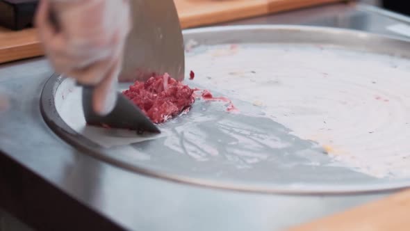 Closeup Hands of Cook Chop Berry Puree Smear in Pan Prepare Thai Ice Cream