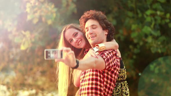 Cute young couple taking selfies and laughing