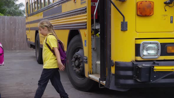 Students get off school bus, slow motion