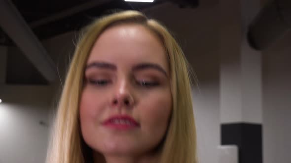 A Young Beautiful Woman Trains in a Gym - Face Closeup