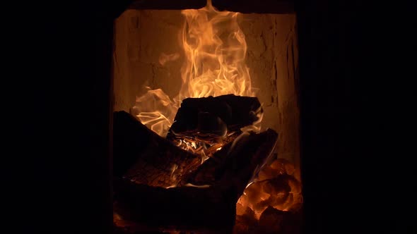 Firewood burning in tile stove / cockle 180 fps slow motion