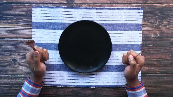 Cutlery and Empty Plate on Wooden Background Top Down