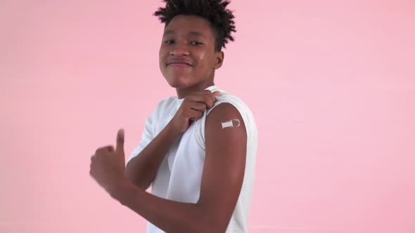 African American Teenager Showing COVID19 Vaccine Bandage Merrily