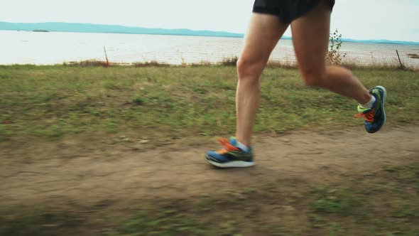 Woman Jogging along Lakeside