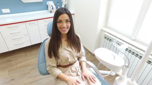 Close up of beautiful smiling woman with healthy white teeth at dentist