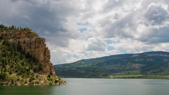 Time lapse of clouds moving over reservoir in the Utah Mountains