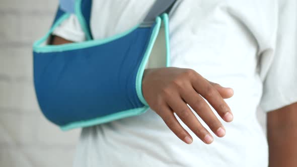 Young Man Wearing an Arm Brace for Broken Hand