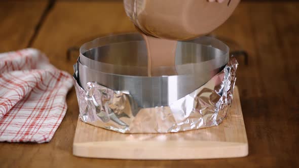 Confectioner Pouring Chocolate Mousse Into A Pastry Ring