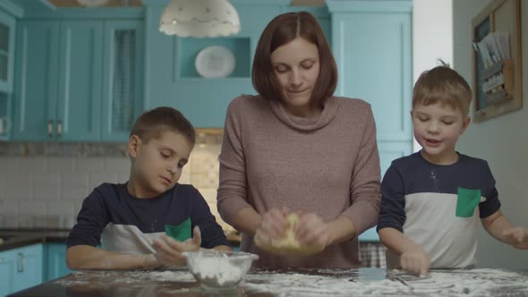 Happy family having fun with flour while cooking cookies