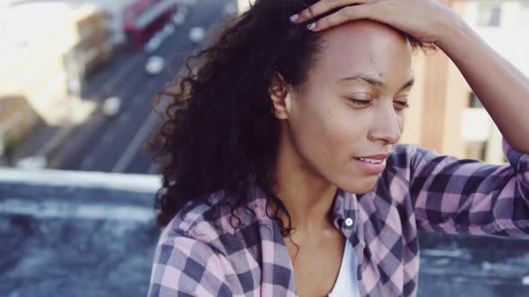 Fashionable young woman on urban rooftop