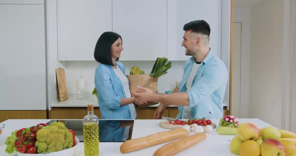 Attractive Happy Smiling Couple Gethering to Cook Family Dinner Together on Modern Cuisine