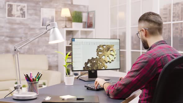 Back View of Male Engineer Working on a Mechanical Concept