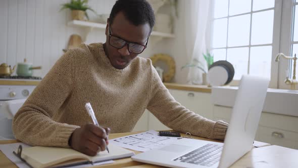 Young African American Man Works Online Looking at Flat Key