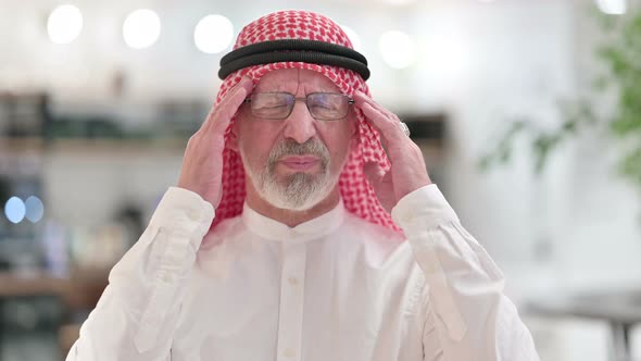 Stressed Senior Old Arab Businessman Having Headache