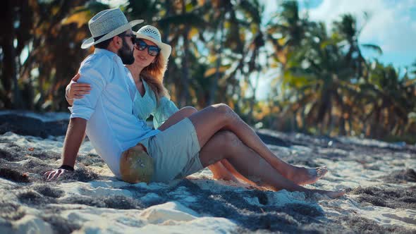 Happy Romantic Couple Enjoying Relaxing Vacation On Caribbean Resort. Loving Couple Sitting Together