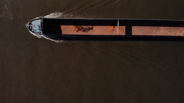 Top View Of A Empty Cargo Ship Traveling On The Oude Mass River At Barendrecht Town In Netherlands.