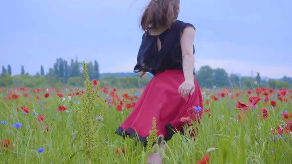 Pretty Girl Running and Dancing in a Poppy Field Smiling Happily