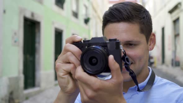 Happy Cheerful Young Man Taking Pictures in Old City Street