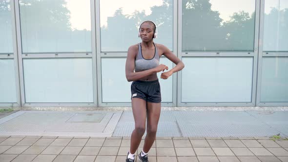 Slow motion shot of young woman dancing in city