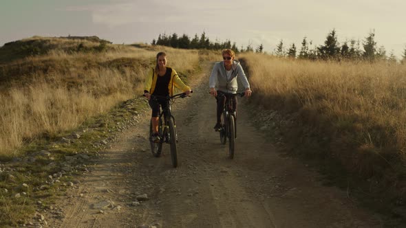 Couple Riding Sport Bicycles on Road