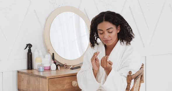 Hygiene and Care About Nails. Young Black Lady Making Beauty Procedures for Her Fingernails at Home