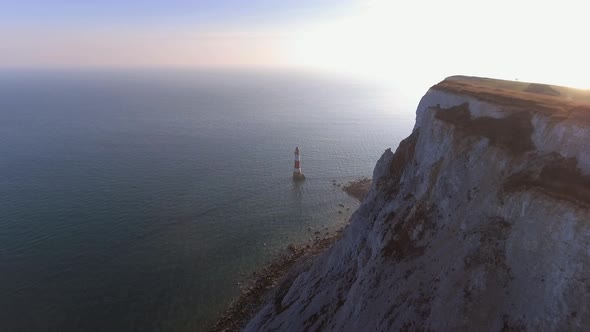 Flying Towards Lighthouse in the Sea at Sunset