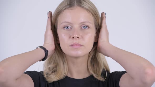 Face of Young Beautiful Blonde Woman Covering Ears As Three Wise Monkeys Concept