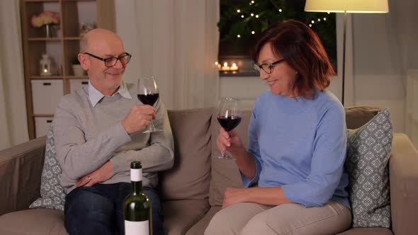 Happy Senior Couple with Glasses of Red Wine