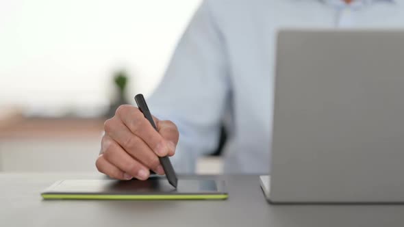 African Man Hands Designing on Tablet with Stylus Close Up