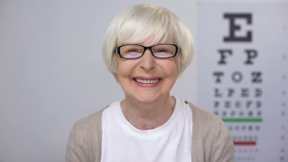 Senior Female in Eyeglasses Smiling to Camera Satisfied With Service Quality