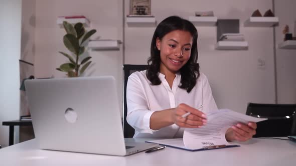 HR Manager Scrolls Through Resume Through Video Meeting on Computer with Spbi Candidate