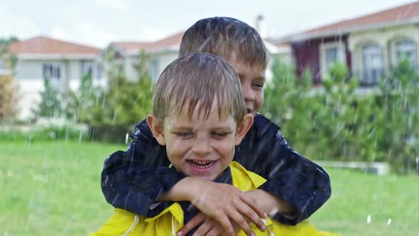 Happy Brothers Hugging in Rain