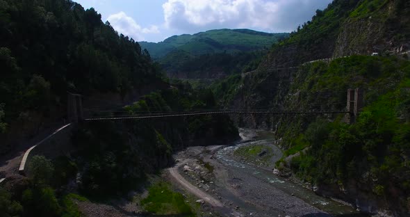 Wooden bridge at river, and mountains in Kashmir, India, Dry river going through mountains, Green Hi