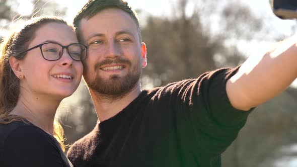 Young Couple in Love Taking Photo of Themself on a Film Camera