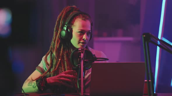 Woman with Dreadlocks on Podcast