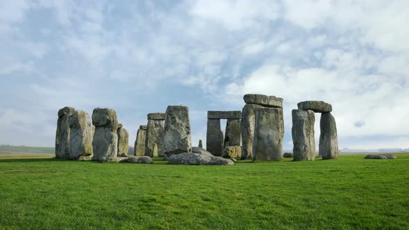 Wide time-lapse of Stonehenge with white clouds