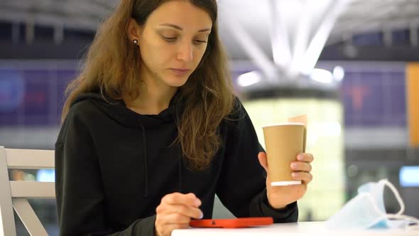 A Girl Holding a Cup of Coffee in Hand