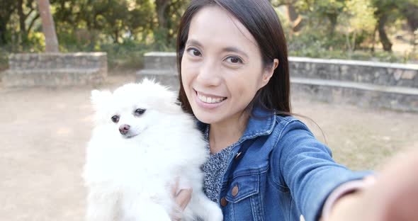 Woman taking selife with her dog at outdoor park