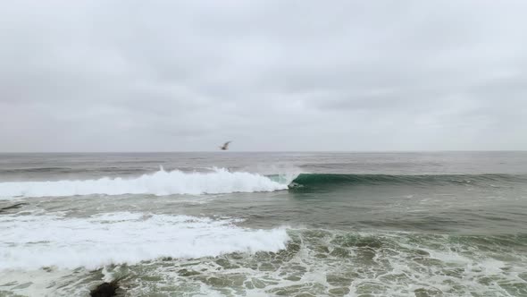 perfect wave for surfing, on the coast of chile, pichilemu secret surf spot. jet ski behind the wave