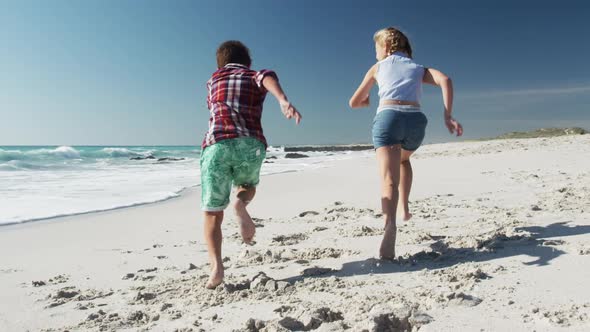 Boy and girl enjoying free time on the beach together