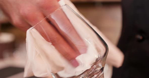 Extreme Closeup of a Male Hand Polishing the Empty Glass