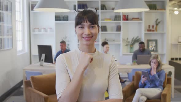 Young woman smiling to camera at the office