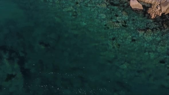 Aerial Shot of Mountain Cliff and Blue Sea Water